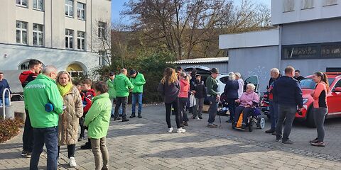 Eine Gruppe Personen, einige mit grünen Greenpeace-Jacken, auf dem Max-Saydewitz-Platz.